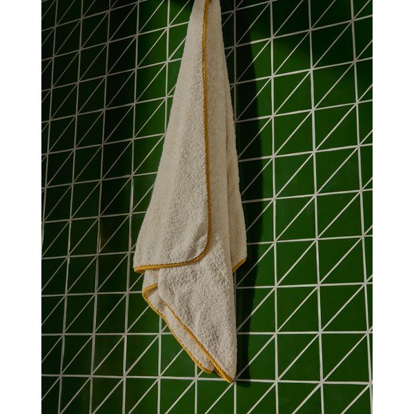 Žltá/biela froté bavlnená osuška 70x140 cm Sedora – Kave Home-image-1