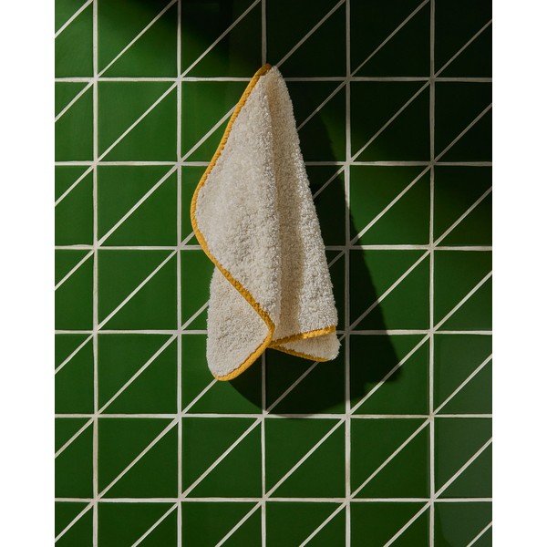 Žltý/biely froté bavlnený uterák 30x50 cm Sedora – Kave Home-image-1